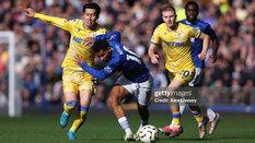 Daichi Kamada tussles for the ball