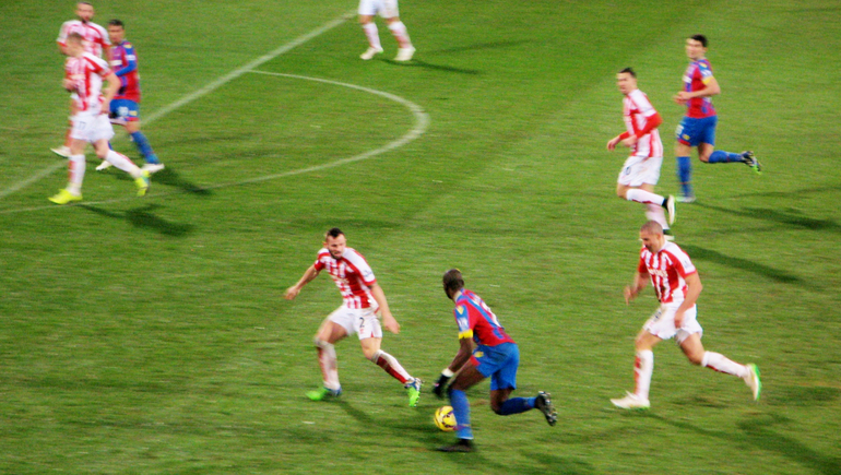 Yannick Bolasie, never daunted, runs at a packed Stoke defence.