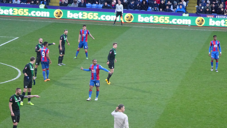 Puncheon conducts the choir as Clattenburg wonders why are the crowd singing 