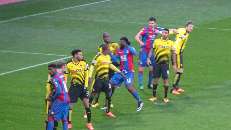 All in a row... Adebayor tries to muscle his way through the Watford defence