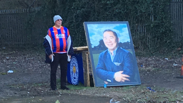 A Palace fan pays his respects at the memorial to the late Leicester owner, Vichai Srivaddhanaprabha