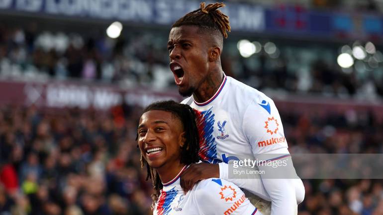 Olise celebrates with Zaha