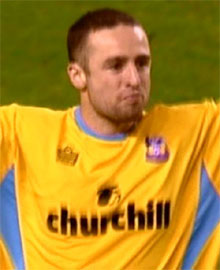 Michael Hughes celebrates after scoring the winning penalty