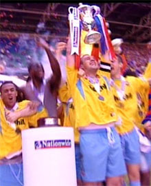 Neil Shipperley holds aloft the play-off trophy