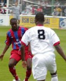 Woking's Raphael Nade takes on Aarron Fray