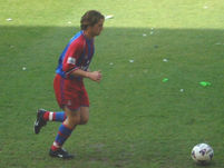 Tommy Black runs with the ball towards the corner flag.