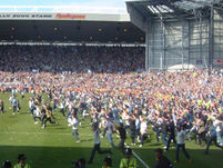 The final whistle blows and thousands of West Brom fans take to the pitch in celebration of their promotion to the Premiership.