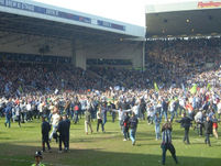Fans on the pitch.