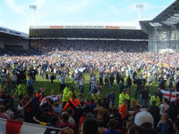 Fans on the pitch.