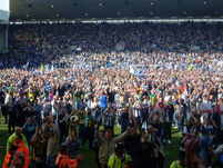 West Brom fans on the pitch.