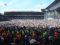 Fans on the pitch.