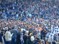 West Brom fans attempt to return to the stands to await a lap of honour by their players.