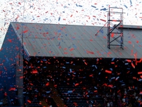 The Holmesdale Road end is covered in shower of Red and Blue ticker