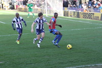 Yannick Bolasie protects the ball from WBA defender Jones.