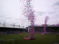 Hundreds of balloons are set off as the players take to the pitch