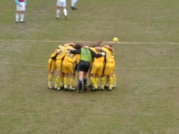 The Palace players huddle together before kickoff