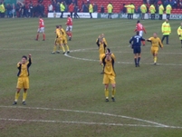 The Palace players applaud the travelling support