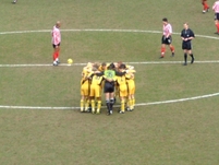 The players form a huddle before the start of the game