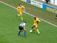 Clinton Morrison holds up the ball, as Craig Harrison runs down the wing