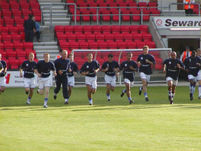 Players doing their runs on their warmup routine