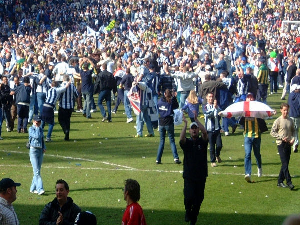 Fans on the pitch.