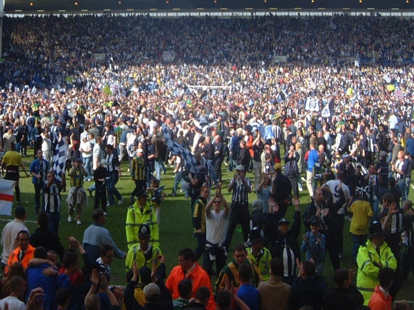 Fans on the pitch.