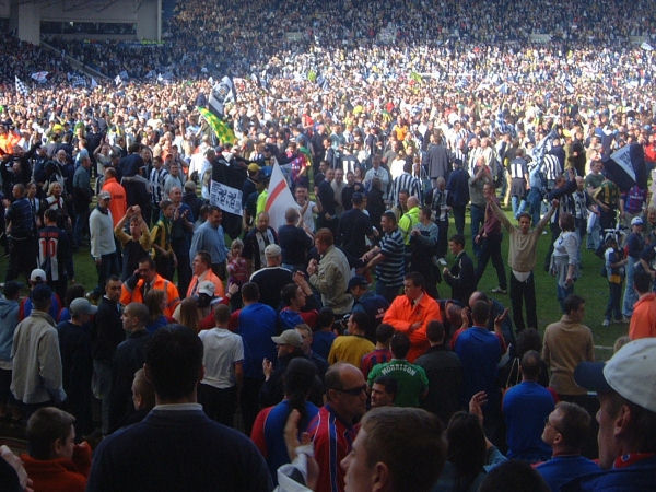 Fans on the pitch.