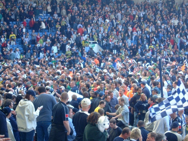 West Brom fans attempt to return to the stands to await a lap of honour by their players.