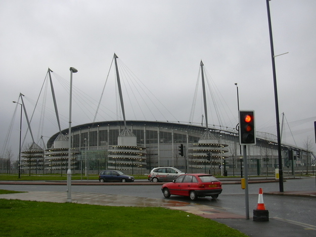 City of Manchester Stadium 2 [Note cars with hubcaps].JPG