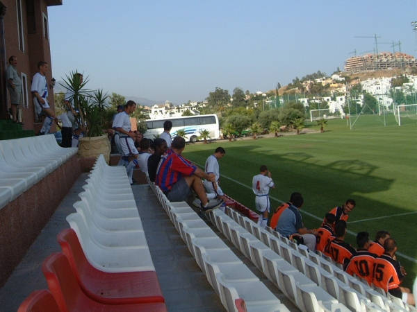 Players take to the pitch as the crowd looks on