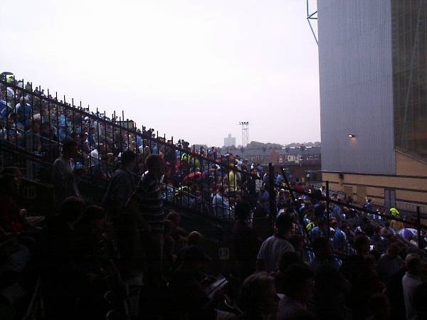 View of some of the Man City fans housed in temporary seats without cover