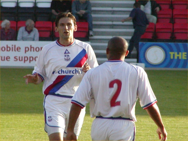 Tony Popovic exchanges words with Curtis Flemming prior to kickoff